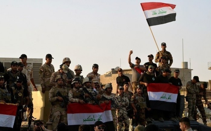 عناصر من القوات العراقية يوم الإعلان عن تحرير الموصل بالكامل